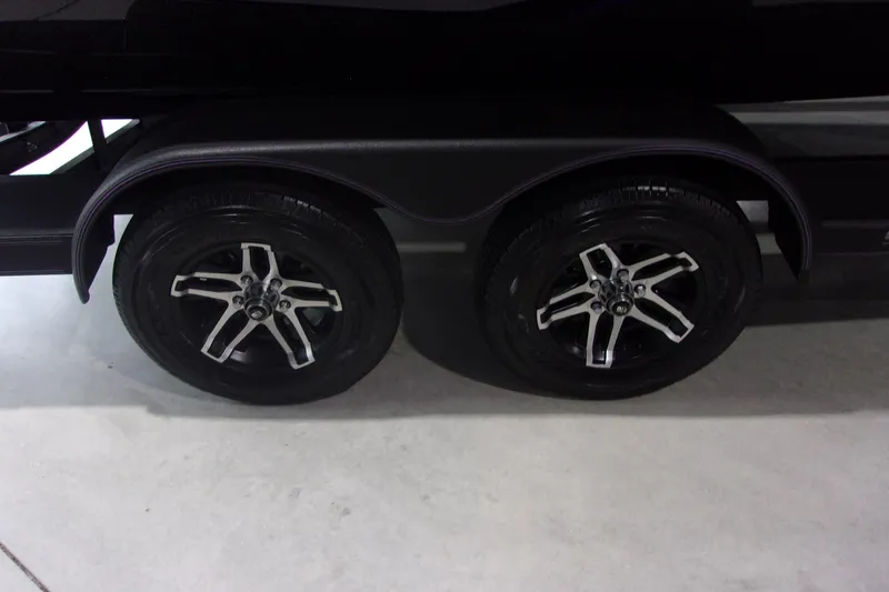 Slide: The Image of 2025 Skeeter ZXR21 trailer wheels with sleek black and silver rims. - 13