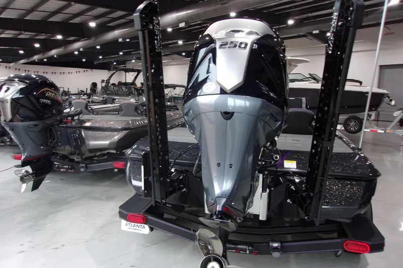 Slide: The Image of 2025 Skeeter ZXR21 boat with powerful outboard motor in showroom setting. - 4