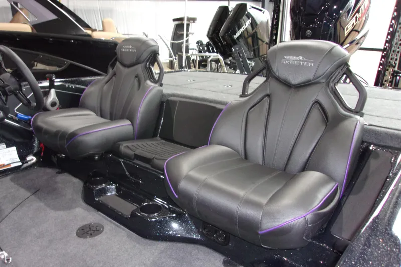 Slide: The Image of 2025 Skeeter ZXR21 boat interior with sleek black seats and purple accents. - 5