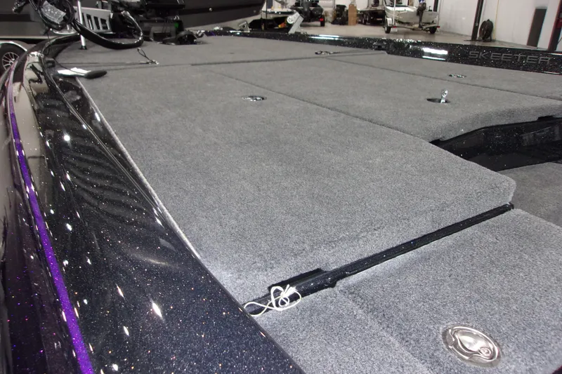 Slide: The Image of 2025 Skeeter ZXR21 boat deck with gray carpet and sleek design. - 6