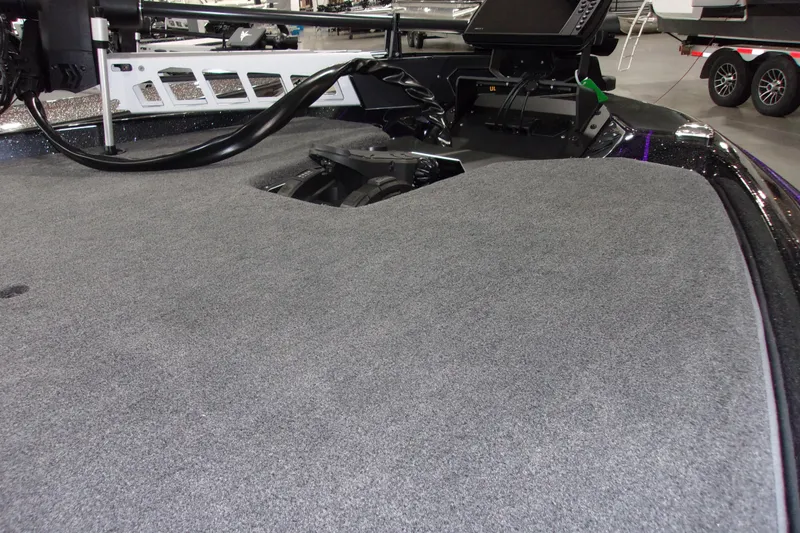 Slide: The Image of 2025 Skeeter ZXR21 boat deck with advanced control panel and carpeted surface. - 9