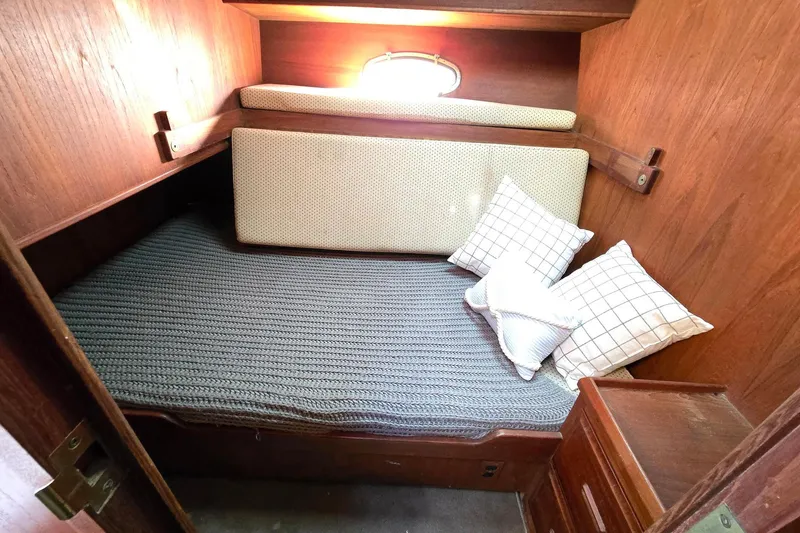 Slide: The Image of Cozy cabin interior of 1991 Cooper Marine Prowler with cushions and wooden finish. - 10