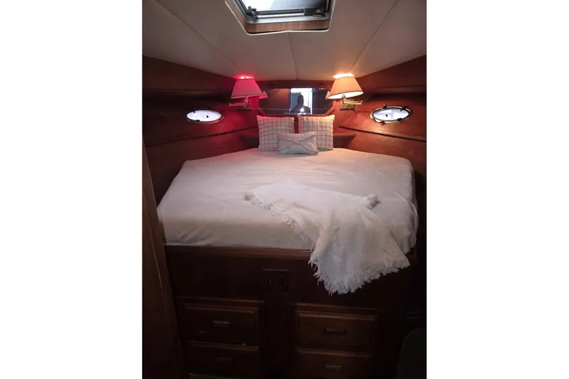 Slide: The Image of Cozy cabin interior of 1991 Cooper Marine Prowler with bed, lamps, and portholes. - 12