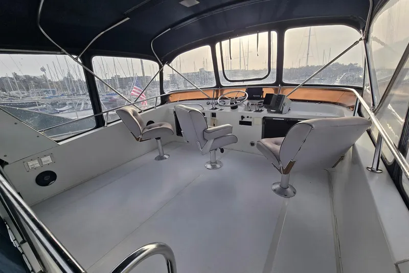 Slide: The Image of Interior of 1991 Cooper Marine Prowler boat with helm and seating, docked at marina. - 18