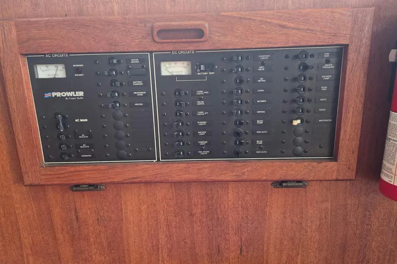 Slide: The Image of 1991 Cooper Marine Prowler electrical panel with AC and DC circuits, wooden frame. - 7