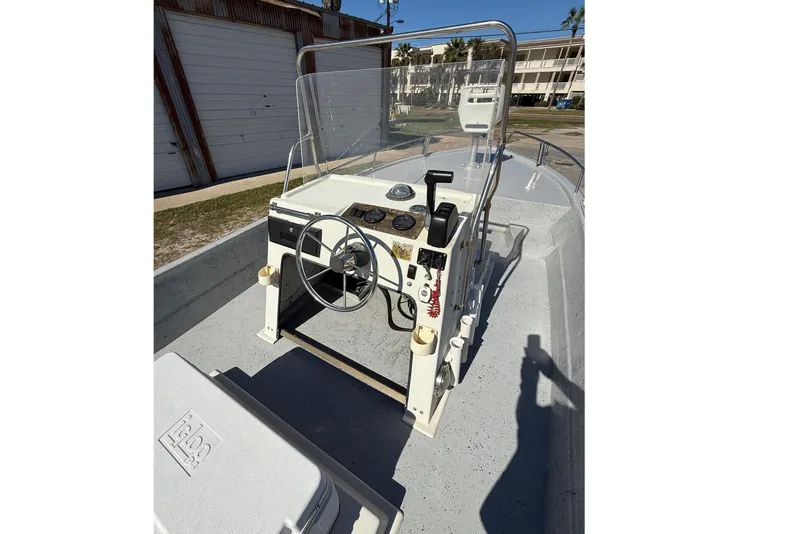 Slide: The Image of 1991 Shallow Sport 21 boat with steering console and Igloo cooler. - 4