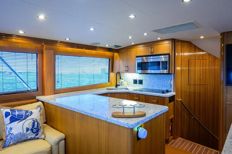 Slide: The Image of Luxurious kitchen interior of 2001 Hatteras 60 Convertible yacht with modern amenities. - 13