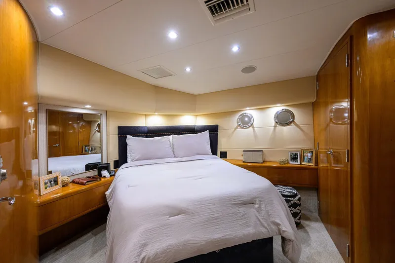 Slide: The Image of Luxurious bedroom interior of 2001 Hatteras 60 Convertible yacht with elegant wood finishes. - 19