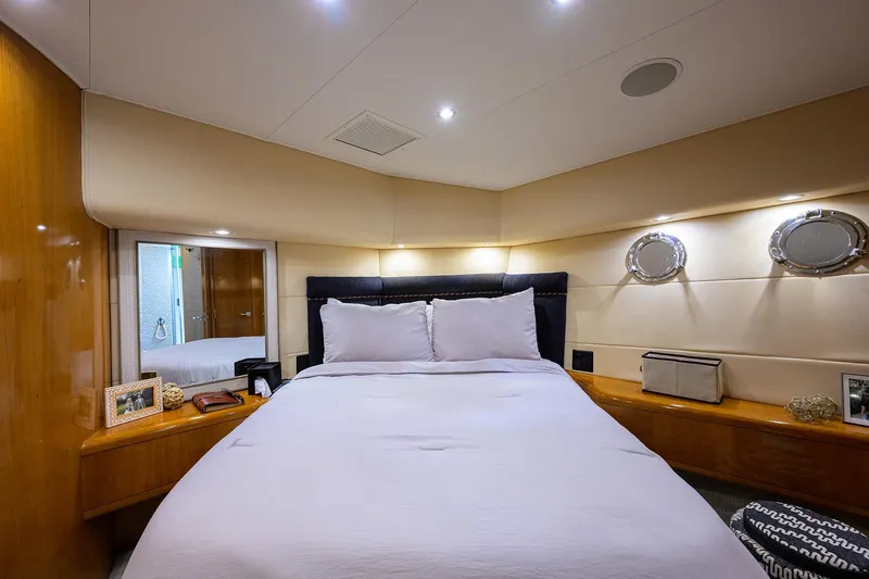 Slide: The Image of Luxurious bedroom interior of 2001 Hatteras 60 Convertible yacht with elegant decor. - 20