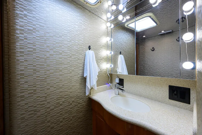 Slide: The Image of Luxurious bathroom in 2001 Hatteras 60 Convertible yacht with elegant lighting and modern fixtures. - 24