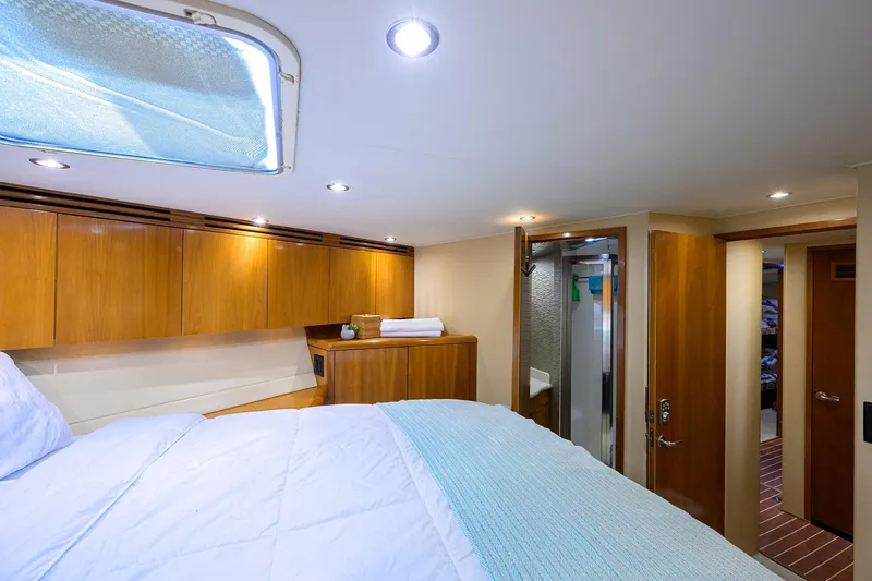 Slide: The Image of Luxurious cabin interior of 2001 Hatteras 60 Convertible yacht with wood finishes. - 29