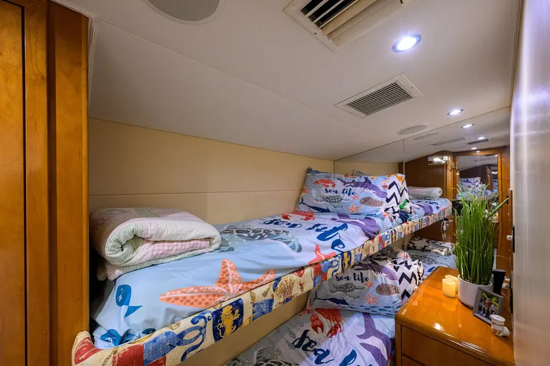 Slide: The Image of Bunk beds in 2001 Hatteras 60 Convertible yacht cabin with nautical-themed bedding. - 34
