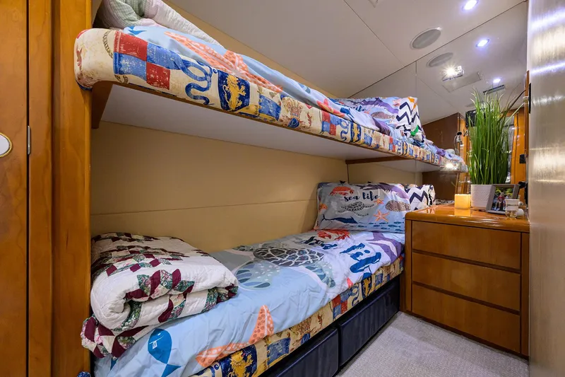 Slide: The Image of Bunk beds in 2001 Hatteras 60 Convertible yacht cabin with colorful bedding and wooden cabinetry. - 35