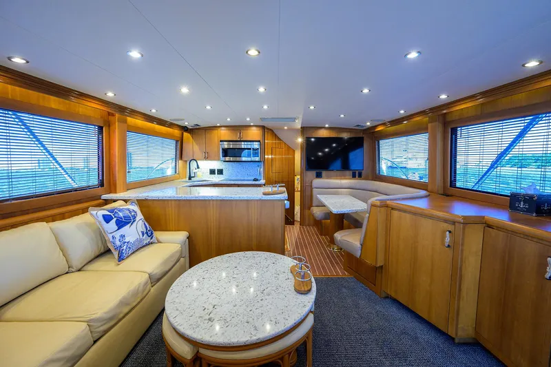 Slide: The Image of Luxurious interior of 2001 Hatteras 60 Convertible yacht with modern kitchen and seating area. - 5