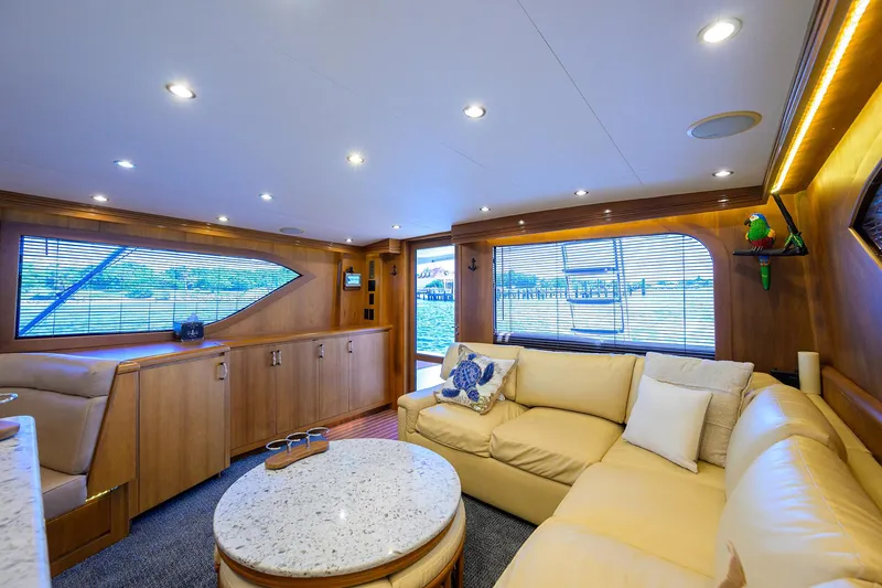 Slide: The Image of Luxurious interior of 2001 Hatteras 60 Convertible yacht with plush seating and elegant decor. - 9