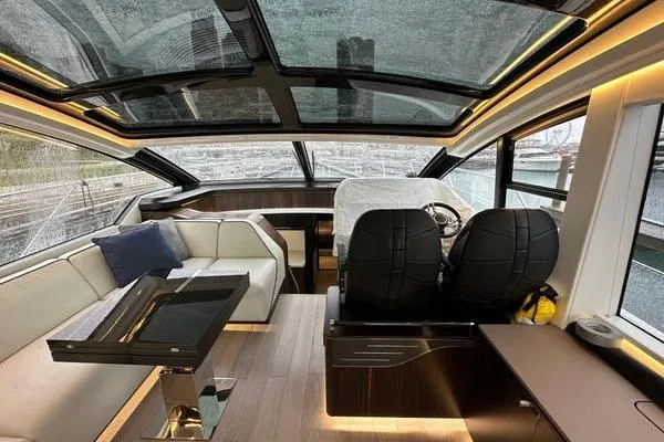 Slide: The Image of Luxurious interior of 2021 Sunseeker Predator 60 EVO yacht with panoramic windows and modern seating. - 12