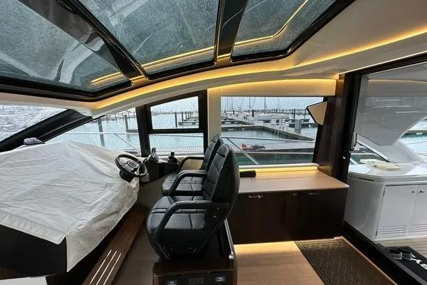 Slide: The Image of Luxurious interior of 2021 Sunseeker Predator 60 EVO yacht with panoramic windows and sleek design. - 13