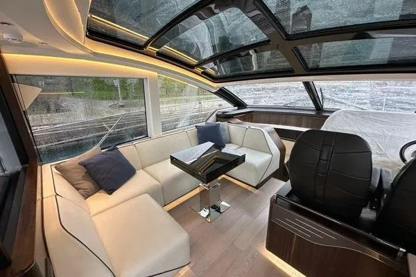 Slide: The Image of Luxurious interior of 2021 Sunseeker Predator 60 EVO yacht with modern seating and panoramic windows. - 14
