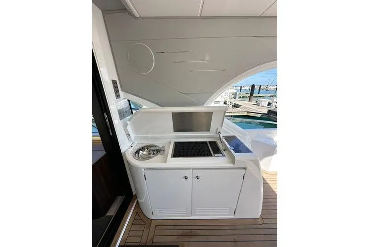 Slide: The Image of Outdoor kitchen on 2021 Sunseeker Predator 60 EVO yacht, featuring grill and sink. - 18