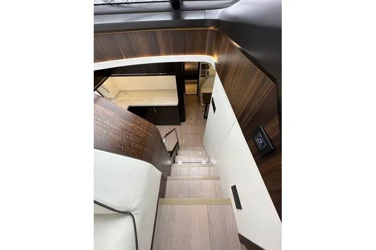 Slide: The Image of Interior staircase of 2021 Sunseeker Predator 60 EVO yacht, featuring modern wood paneling. - 19
