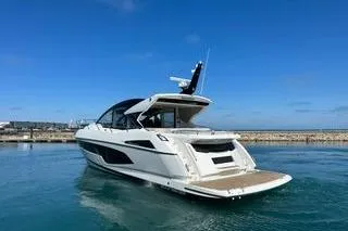 Slide: The Image of 2021 Sunseeker Predator 60 EVO yacht on calm water, clear sky background. - 2