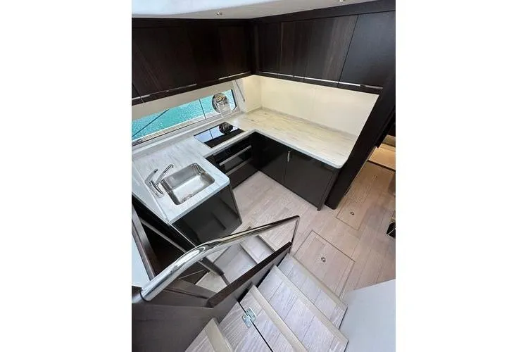 Slide: The Image of Modern kitchen interior of 2021 Sunseeker Predator 60 EVO yacht, featuring sleek cabinetry and countertops. - 20