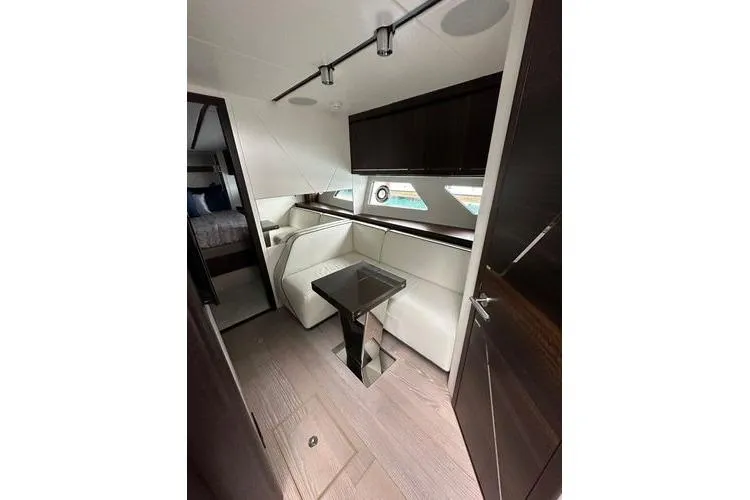 Slide: The Image of Luxurious interior of 2021 Sunseeker Predator 60 EVO yacht with modern seating and table. - 21