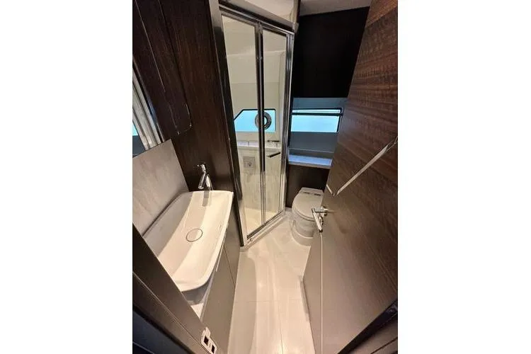 Slide: The Image of Luxurious bathroom in 2021 Sunseeker Predator 60 EVO yacht, featuring modern fixtures and sleek design. - 28
