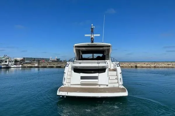 Slide: The Image of 2021 Sunseeker Predator 60 EVO yacht docked in a serene marina setting. - 40