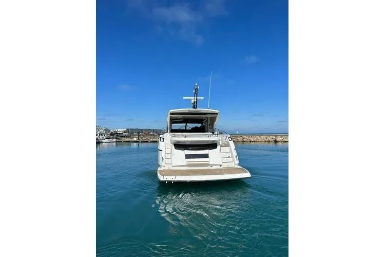 Slide: The Image of 2021 Sunseeker Predator 60 EVO yacht docked in clear blue water. - 42