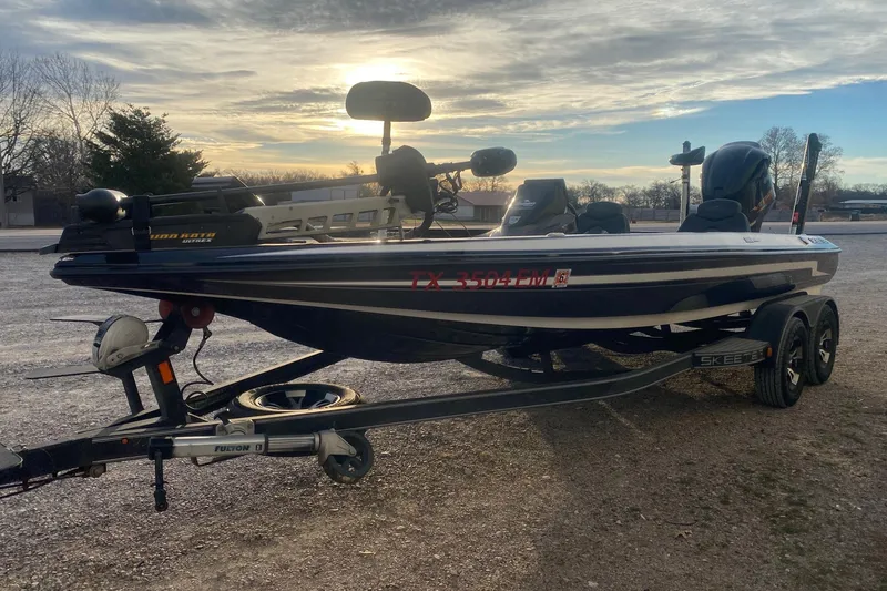 Slide: The Image of 2019 Skeeter ZX250 boat on trailer at sunset, featuring Minn Kota trolling motor. - 3