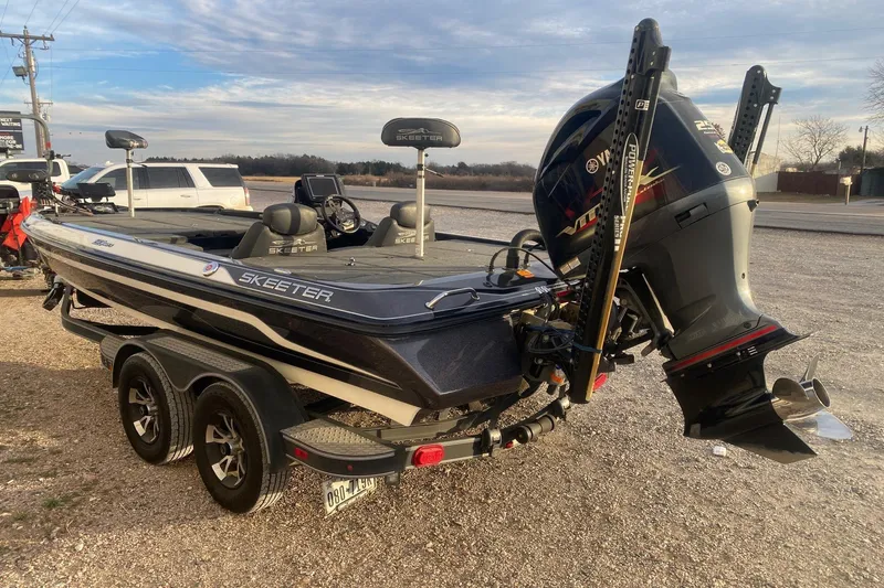 Slide: The Image of 2019 Skeeter ZX250 boat with Yamaha outboard motor on a trailer. - 4