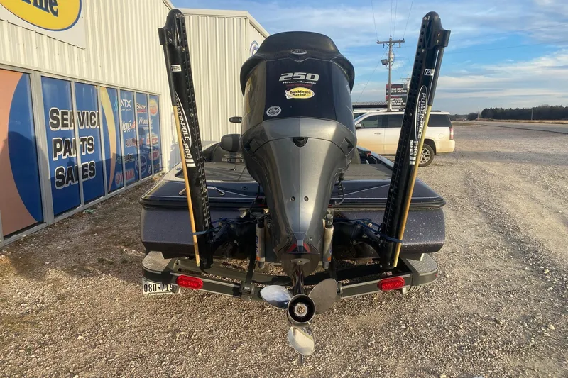 Slide: The Image of 2019 Skeeter ZX250 boat with powerful outboard motor, parked near service center. - 5