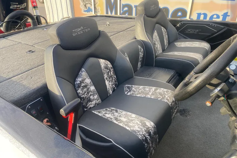 Slide: The Image of 2019 Skeeter ZX250 boat interior with camo-patterned seats and steering wheel. - 7