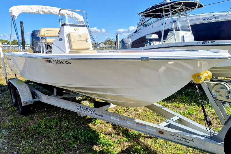 The Image of 2017 Sportsman Masters 207 Bay Boat docked at sunset with palm trees. - 0
