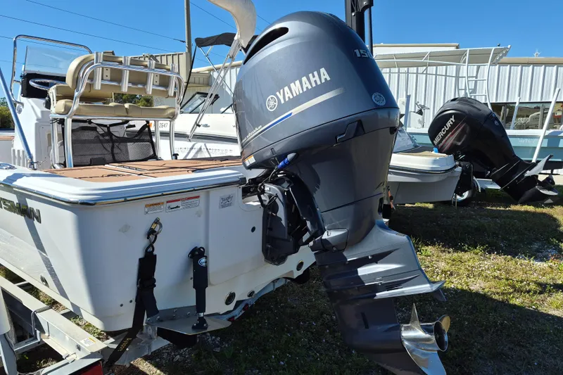Slide: The Image of 2017 Sportsman Masters 207 Bay Boat on trailer, parked outdoors under clear blue sky. - 3