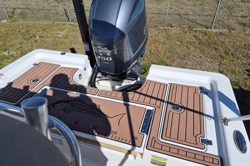Slide: The Image of 2017 Sportsman Masters 207 Bay Boat with SeaDek flooring, displayed on grass. - 8