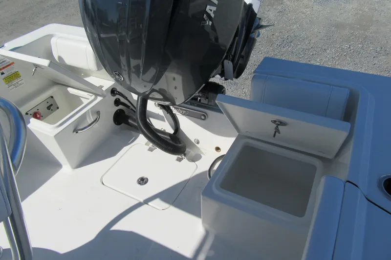 Slide: The Image of 2026 Parker 180 Coastal Elite boat interior with open storage compartments and engine view. - 12