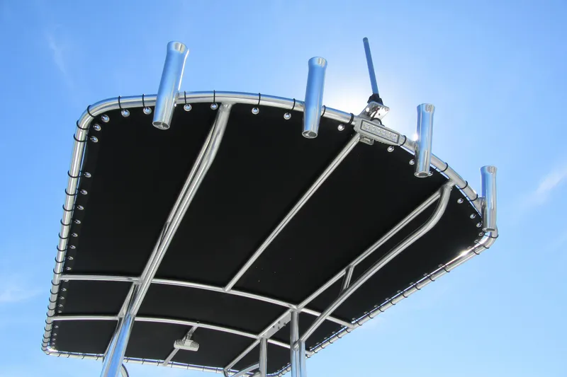 Slide: The Image of T-top of 2026 Parker 180 Coastal Elite boat against clear blue sky. - 13