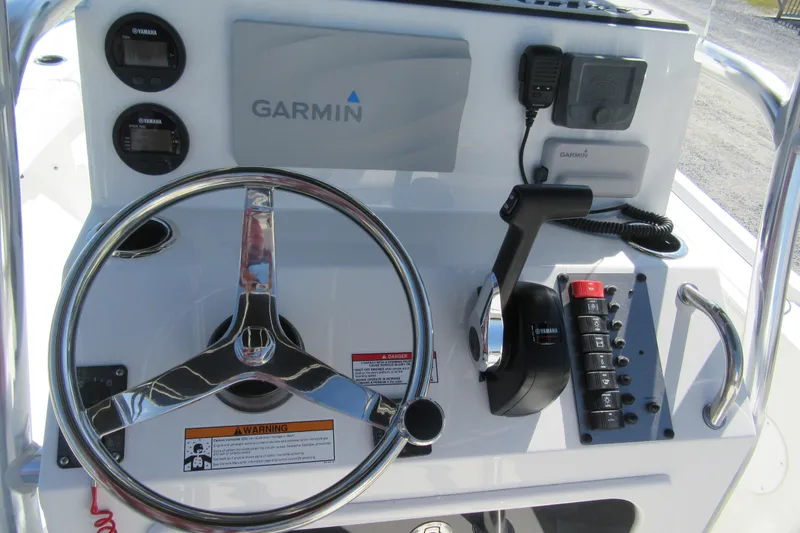 Slide: The Image of 2026 Parker 180 Coastal Elite boat dashboard with Garmin navigation and Yamaha controls. - 16