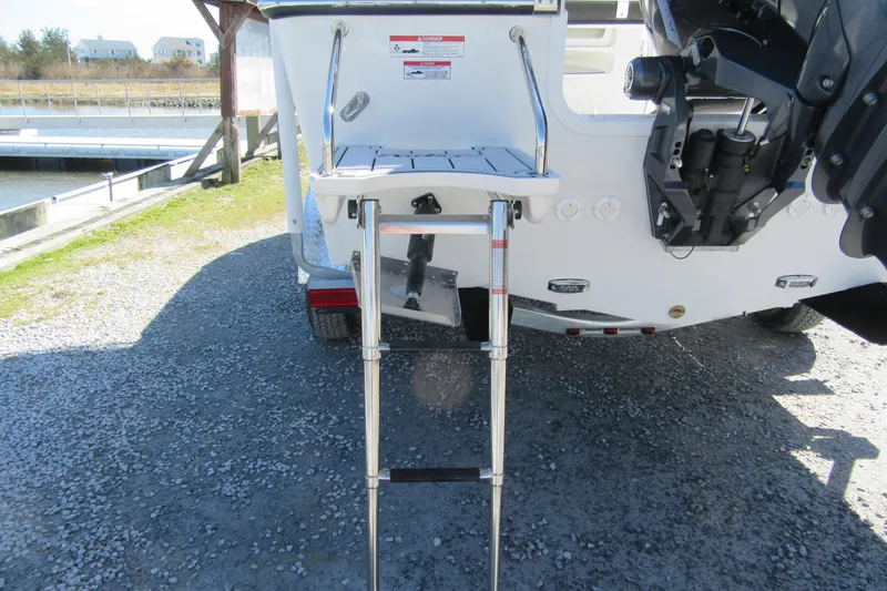 Slide: The Image of 2026 Parker 180 Coastal Elite boat with ladder and motor at dockside. - 17