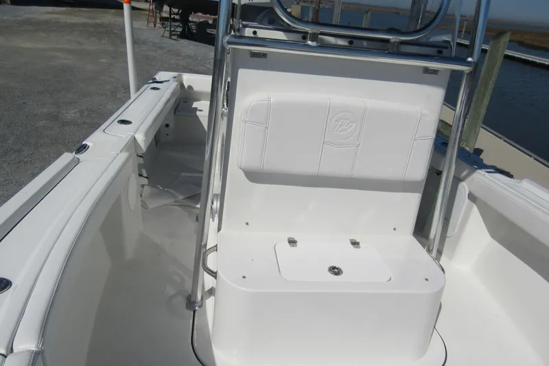 Slide: The Image of 2026 Parker 180 Coastal Elite boat interior with white seating and storage. - 7