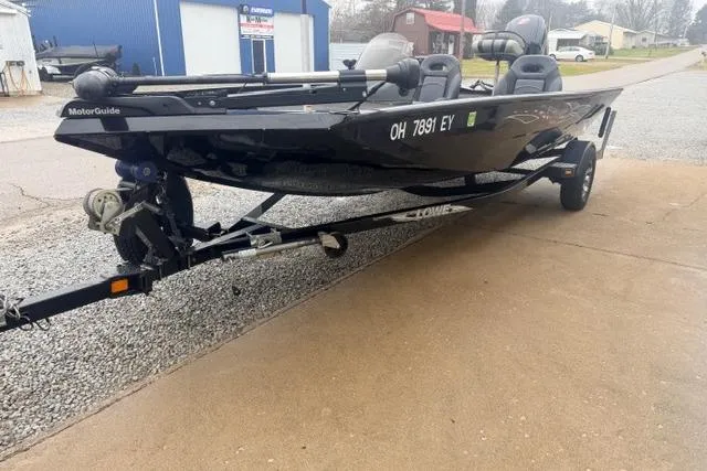 Slide: The Image of 2012 Lowe Stinger 18 HP boat on trailer, parked outdoors. - 11