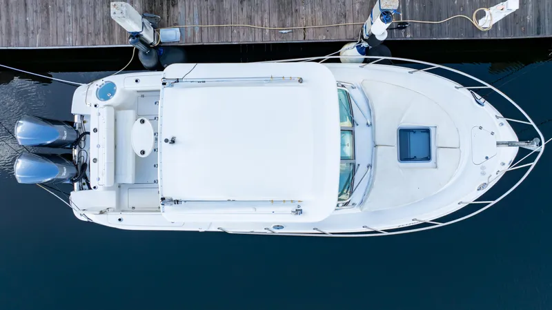 Slide: The Image of Aerial view of 2010 Robalo R305 Walkaround boat docked at a marina. - 14