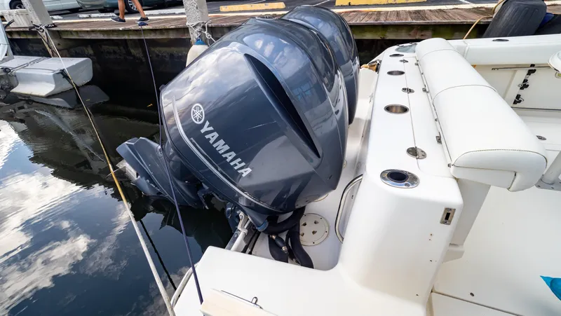 Slide: The Image of 2010 Robalo R305 Walkaround with Yamaha outboard engines docked at marina. - 18