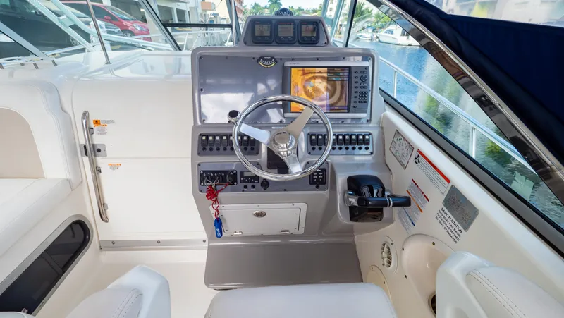Slide: The Image of 2010 Robalo R305 Walkaround helm with modern navigation equipment and controls. - 2