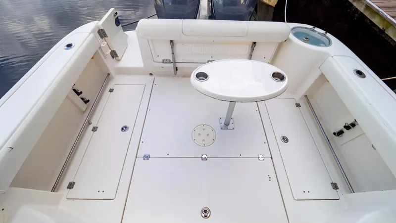 Slide: The Image of 2010 Robalo R305 Walkaround boat deck with seating and table. - 22