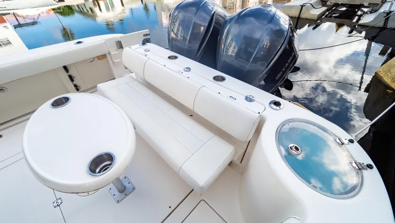 Slide: The Image of 2010 Robalo R305 Walkaround boat interior with seating and twin engines. - 23