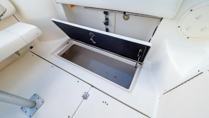 Slide: The Image of Open storage compartment on 2010 Robalo R305 Walkaround boat interior. - 27