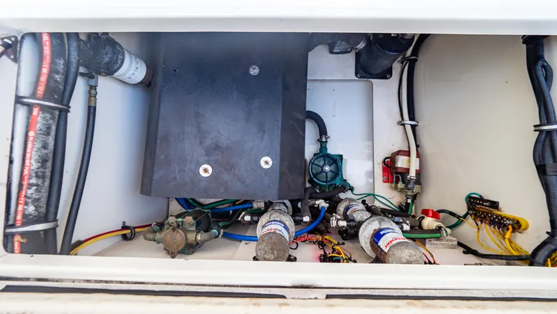 Slide: The Image of 2010 Robalo R305 Walkaround engine compartment with wiring and components. - 28